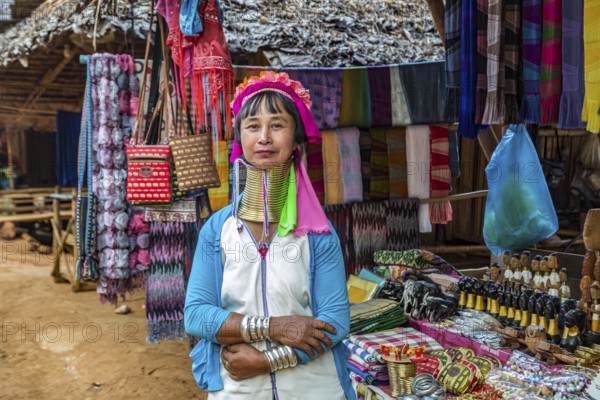 Tribal woman selling woven scarves and other crafts in the Long Neck Karen tribe (more properly called the Kayah Lahwi tribe) area of the Union of Hill Tribe Villages outside of Chiang Rai in the Nanglae District of Thailand