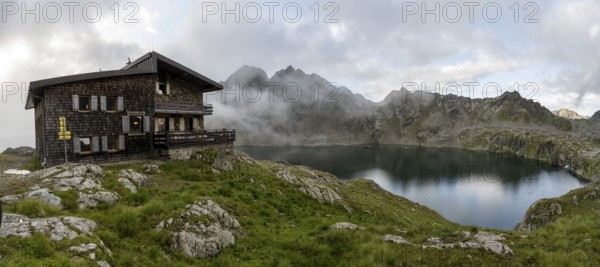Mountain hut Wangenitzseehütte, cloudy mountain landscape with mountain lake Wangenitzsee, Wiener Höhenweg, Schober group, Hohe Tauern National Park, Carinthia, Austria, Europe