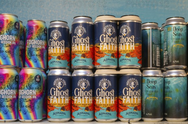 Adnams beer products on display inside brewery shop, Southwold, Suffolk, England, UK - Ghost Faith hazy pale ale cans
