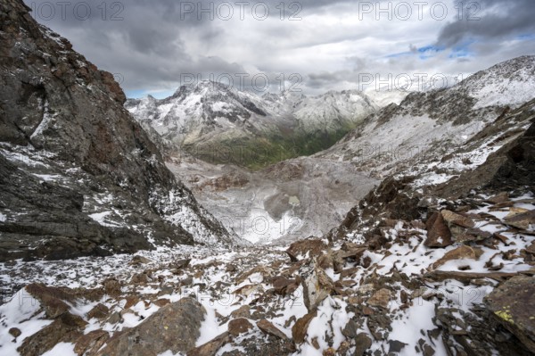 View of steep rocky mountain landscape with fresh snow in summer, in the Hornscharte, on the Wiener Höhenweg, behind summit Roter Knopf, Schober group, Hohe Tauern National Park, Carinthia, Austria, Europe