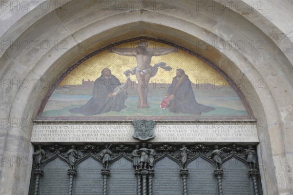Thesis door with tympanum and crucifix with Philipp Melanchthon and Martin Luther, wall mosaic, arts and crafts, UNESCO, castle church, castle, Luther city Wittenberg, Fläming, Saxony-Anhalt, Germany, Europe