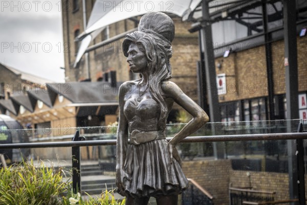 Bronze statue of the late singer amy winehouse, standing proudly in stables market, camden town, london