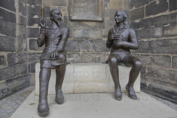 Sculpture Schütz-Novalis Bench by Steffen Ahrens and Grit Berkner 2022, composer Heinrich Schütz, writer Novalis Friedrich von Hardenberg, bench, monument, modern art, two, bronze sculptures, sitting, communication, interaction, pointing finger, listening, telling, talking, market square, Weißenfels, Saxony-Anhalt, Germany, Europe