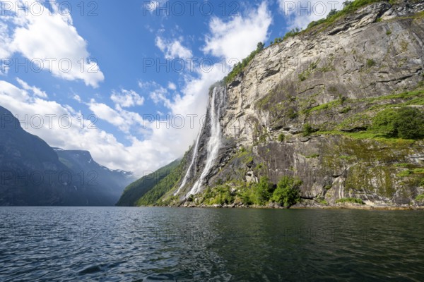 Geirangerfjord at the waterfall The Seven Sisters, tip of a red kayak in the fjord, atmospheric fjord landscape, first person view, near Geiranger, Møre og Romsdal, Norway, Europe