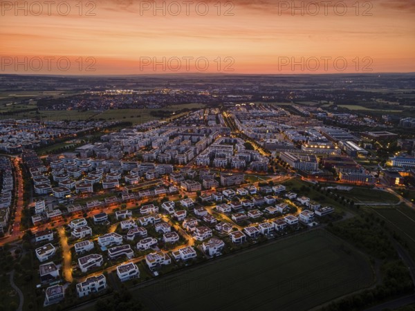 Dawn behind the Riedberg district of Frankfurt heralds the imminent sunrise. (Aerial view with a drone), Germany, Europe