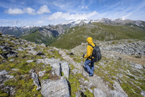 Mountaineers on a hiking trail, view of picturesque mountain landscape with snow-covered summit of the Großglockner, Vienna High Trail, Schober Group, Hohe Tauern National Park, Carinthia, Austria, Europe