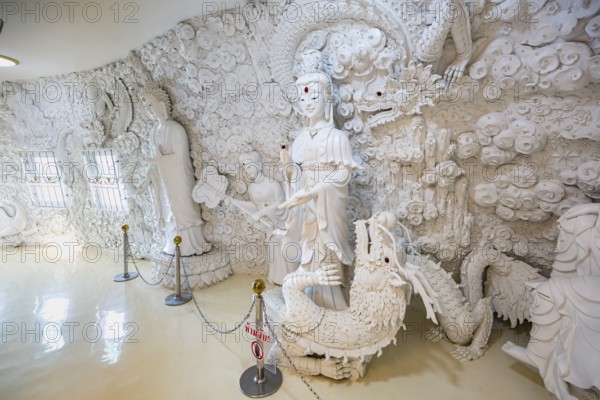 Ornate carvings on the walls at the Guan Yin (Goddess of Mercy) statue at Wat Huay Pla Kang Temple in Chiang Rai province of Northern Thailand
