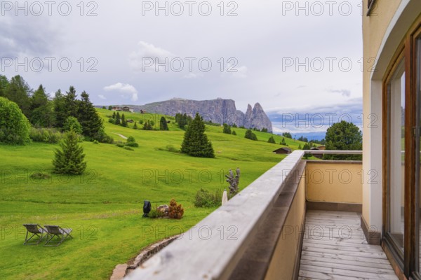 Balcony with a view of a wide green landscape with mountains and clouds, Alpe di Siusi, South Tyrol, Dolomites, Italy, Europe