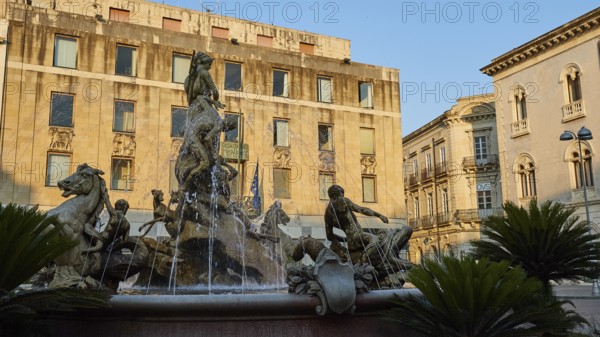 Piazza Archimede, Fontana di Diana, Diana Fountain, Baroque fountain with sculptures of horses and figures in front of old buildings under a blue sky, Ortigia Island, Isola di Ortigia, Historic Old Town, Syracuse, Sicily, Italy, Europe