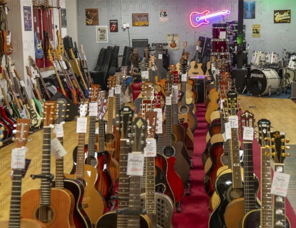Guitars on display inside shop Sarum Guitars & Drums, Salisbury, Wiltshire, England, UK