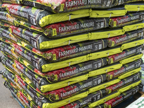 Farmyard manure bags stacked up at Lowden garden centre, Wiltshire, England, UK