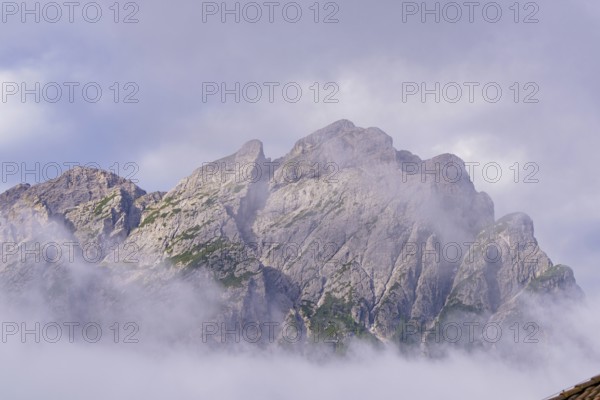 Dramatic mountain peaks shrouded in mystical fog, Dolomites, South Tyrol, Dolomites, Italy, Europe