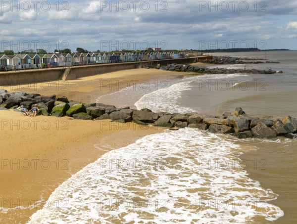 View north of sandy beach and coastal defences from pier, Southwold, Suffolk, England, UK