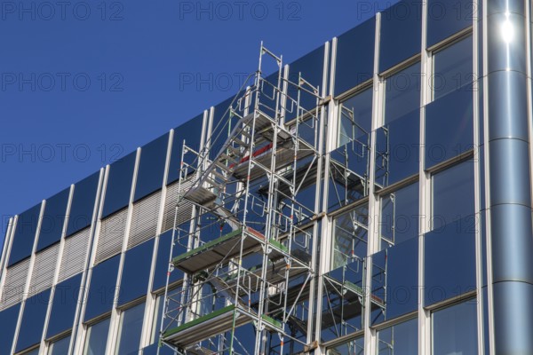 Steel scaffolding on the large glass façade of an office building