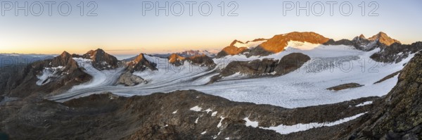 Picturesque high mountain landscape at sunrise with alpenglow, glacier and rocky mountain peaks in the morning light, view at Becher of mountain peaks Königshofspitz and Sonklarspitze and Schwarzwandspitz with glacier Übeltalferner, Stubai Alps, South Tyrol, Italy, Europe