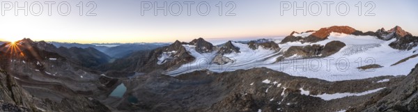 Panorama at sunrise with sun star, high mountain landscape, view of blue glacial lakes, mountain peaks Königshofspitz and Hofmannspitze with glacier of the Übeltalferner, Stubai Alps, South Tyrol, Italy, Europe