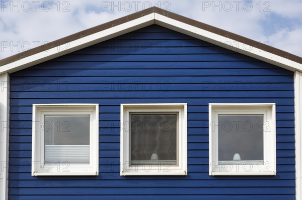 Blue lobster shack, wooden façade with three windows, façade detail in the harbour, Heligoland, Schleswig-Holstein, Germany, Europe
