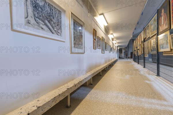 Long gallery corridor with paintings and a bench, historical art exhibition in the old swimming pool, show depot, Calw, Black Forest, Germany, Europe