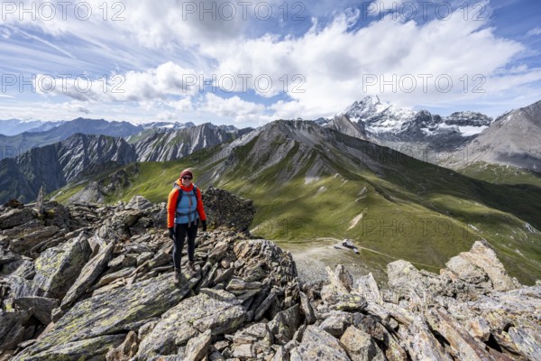 Mountaineer on the summit of Kastenegg, view of picturesque mountain landscape with snow-covered summit of the Großglockner, Vienna High Trail, Schober Group, Hohe Tauern National Park, Carinthia, Austria, Europe