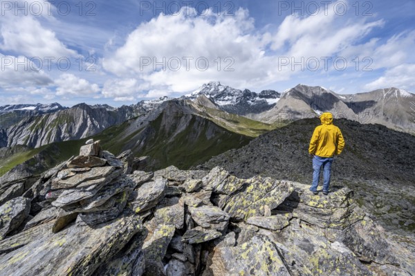 Mountaineer on the summit of Kastenegg, view of picturesque mountain landscape with snow-covered summit of the Großglockner, Vienna High Mountain Trail, Schober Group, Hohe Tauern National Park, Carinthia, Austria, Europe