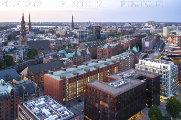 Aerial view of the Speicherstadt with striking brick buildings and high towers under an evening sky, Hamburg, Germany, Europe