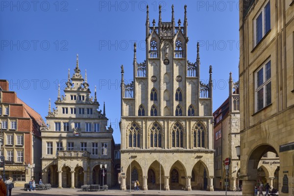 Historic town hall, facade, windows, arcades, gable, cobblestone street, pedestrians as secondary motif, blue cloudless sky, intersection Prinzipalmarkt with Michaelisplatz, Münster, Münsterland, independent city, North Rhine-Westphalia, Germany, Europe