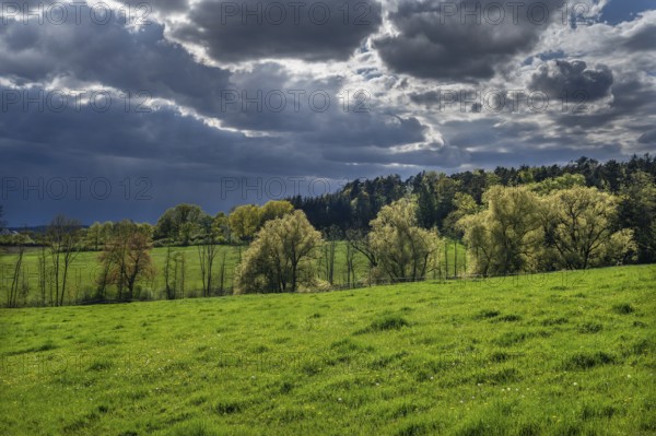 Rising rain clouds in a spring landscape, Franconia, Bavaria, Germany, Europe
