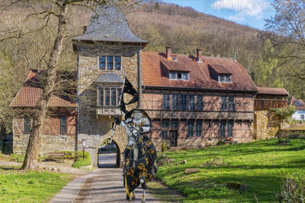 Knight on horseback in front of gatehouse to Schaumburg Germany Composing