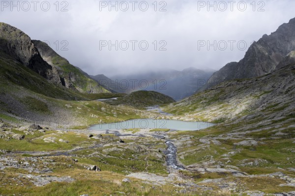 Turquoise-blue mountain lake Mittersee and rainbow, Schober group, Hohe Tauern National Park, Carinthia, Austria, Europe