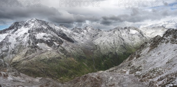 View of steep rocky mountain landscape with fresh snow in summer, in the Hornscharte, on the Wiener Höhenweg, behind summit Roter Knopf, Schober group, Hohe Tauern National Park, Carinthia, Austria, Europe