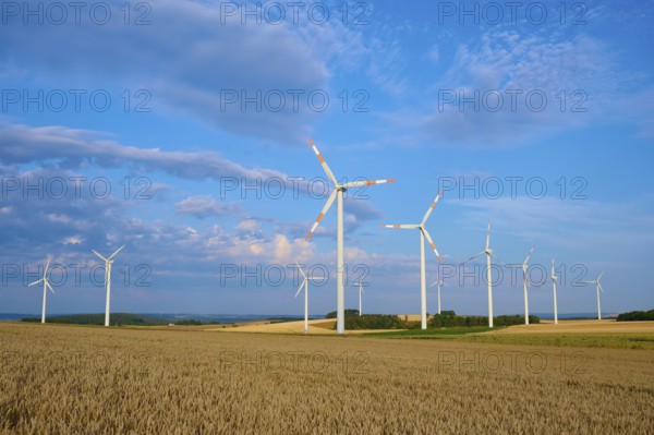 Several wind turbines on a field under blue sky and clouds, summer, Höhefeld, Wertheim, Baden-Württemberg, Germany, Europe