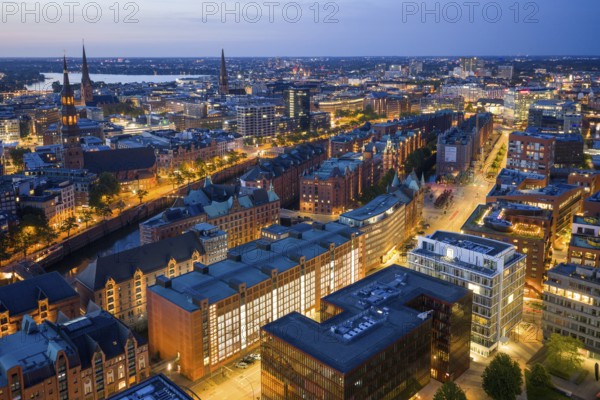 Aerial view of the Speicherstadt Hamburg at blue hour with churches and Alster in the background, Hamburg, Germany, Europe