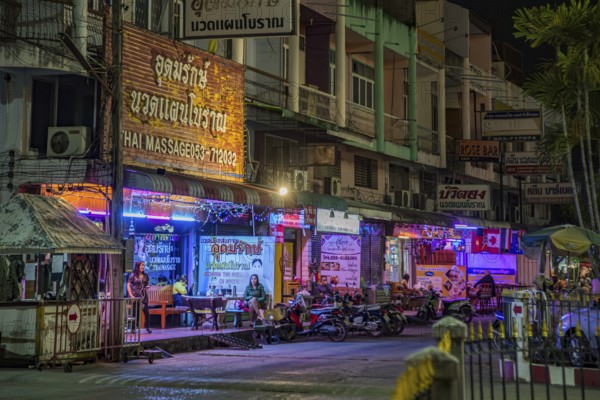 Massage parlor employees waiting for customers along a steet in Chiang Rai, Thailand, Asia