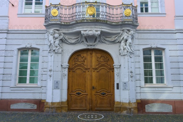 Magnificent wooden door of a pink façade with classical sculptures and decorative details in Baroque style, Freiburg District Court, Freiburg im Breisgau, Black Forest, Baden-Württemberg, Germany, Europe