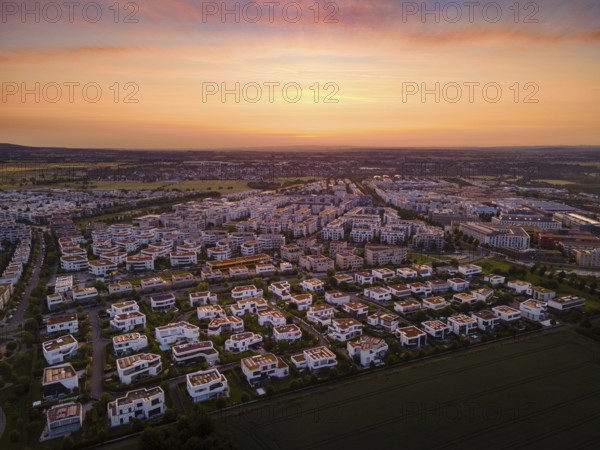 Dawn behind the Riedberg district of Frankfurt heralds the imminent sunrise. (Aerial view with a drone), Germany, Europe
