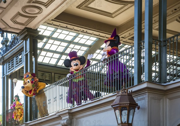 Mickey Mouse, Minnie Mouse, and Pluto welcome guests to the Magic Kingdom at Walt Disney World, Orlando, Florida