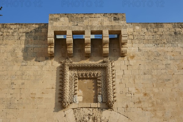 Detailed view of an old wall with architectural decorations under a blue sky, Ortigia Island, Isola di Ortigia, Historic Centre, Syracuse, Sicily, Italy, Europe