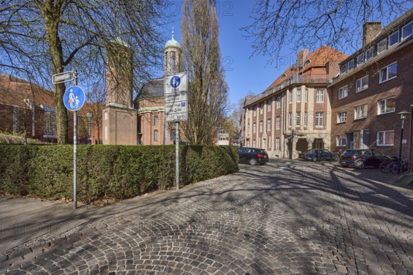 Clemenskirche, church, Baroque architectural style, architect Johann Conrad Schlaun, general architecture, cobblestone street, bare winter trees, hedge, pedestrian zone, traffic sign, blue cloudless sky, intersection An der Clemenskirche with Loerstraße, Münster, Münsterland, independent city, North Rhine-Westphalia, Germany, Europe