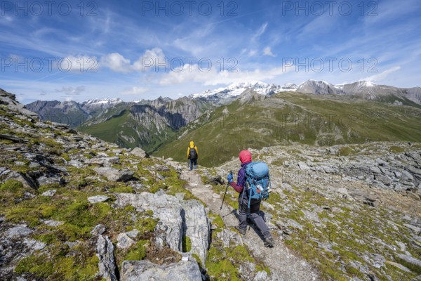 Mountaineers on a hiking trail, view of picturesque mountain landscape with snow-covered summit of the Großglockner, Vienna High Trail, Schober Group, Hohe Tauern National Park, Carinthia, Austria, Europe
