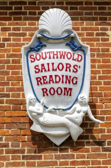 Sign with mermaids on Southwold Sailors Reading Room building, Southwold, Suffolk, England, UK