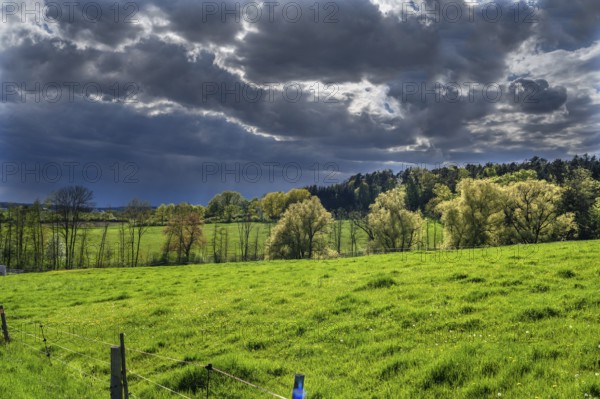Rising rain clouds in a spring landscape, Franconia, Bavaria, Germany, Europe