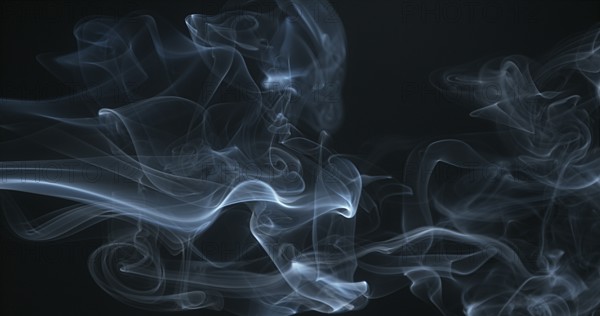 Smoke of Cigarette rising against Black Background