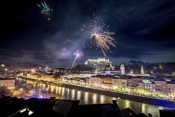 Colorful firework in the night: Old city of Salzburg and Festung Hohensalzburg at New Year?s Eve. Magic