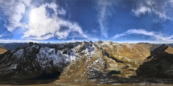 Panoramic shot of a mountain range in summer on a sunny cloudless day. bare rocky cliffs