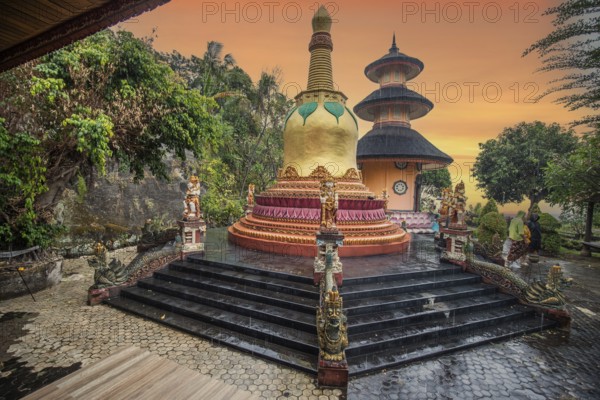 A Buddhist temple in the evening in the rain. The Brahmavihara Arama Temple has beautiful gardens and is also home to a monastery. Tropical plants near Banjar, Bali