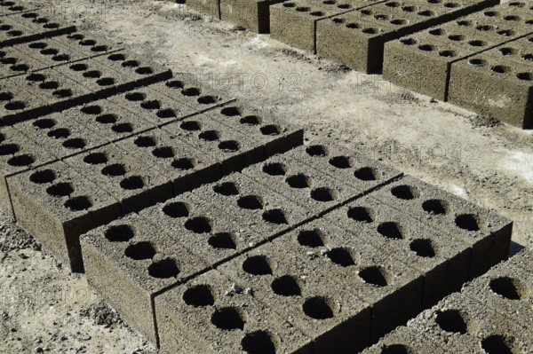 Freshly made cinder blocks on a concrete pad