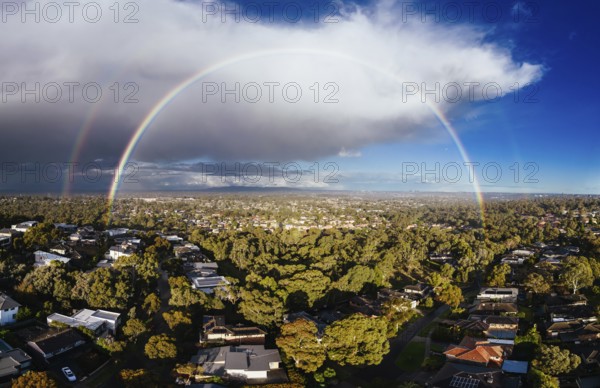 A winter's day storm and rainbow aerial view over the estate of Springthorpe near Bundoora in Macleod, Melbourne, Australia, Oceania