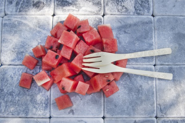 Presentation of a summer dish made of diced watermelon