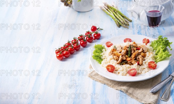 Turkey fricassee on rice with asparagus and peppers