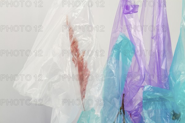 Close up hanging plastic bags with herbs. Isolated on white